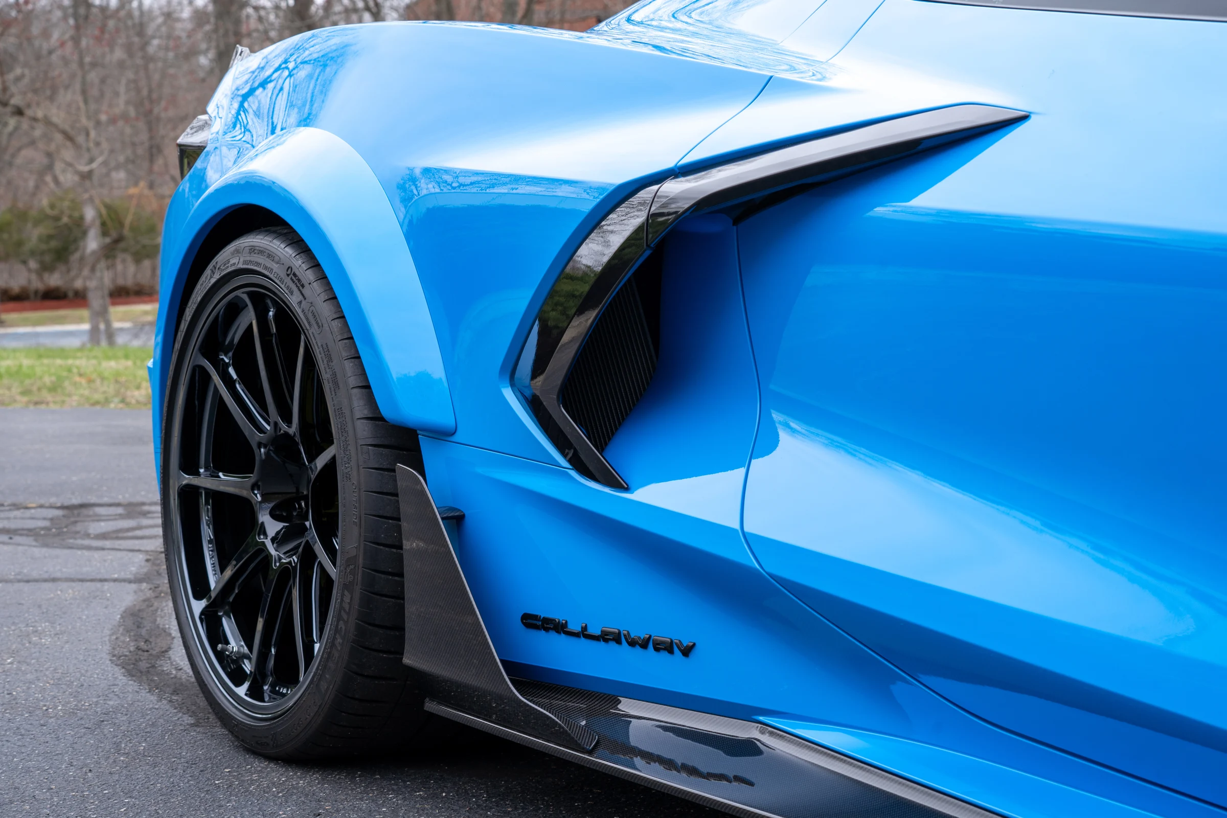 Carbon-fiber rear fender flare and rocker extension on the blue Callaway widebody Stingray